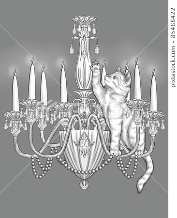 Playful cat on top of a lit candle chandelier