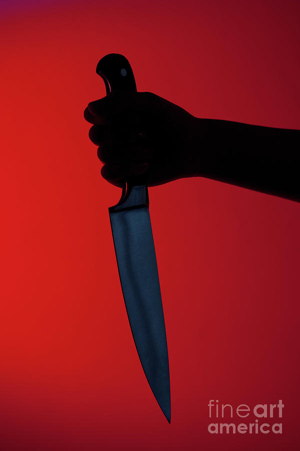Human hand holding kitchen knife by westend