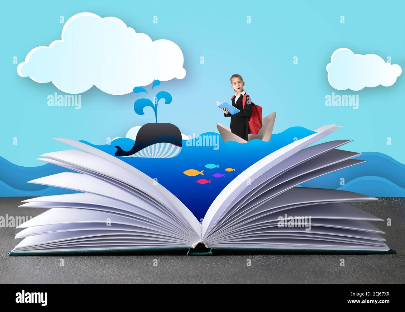 Open book with drawn sea and surprised little schoolgirl in paper boat on color background stock photo
