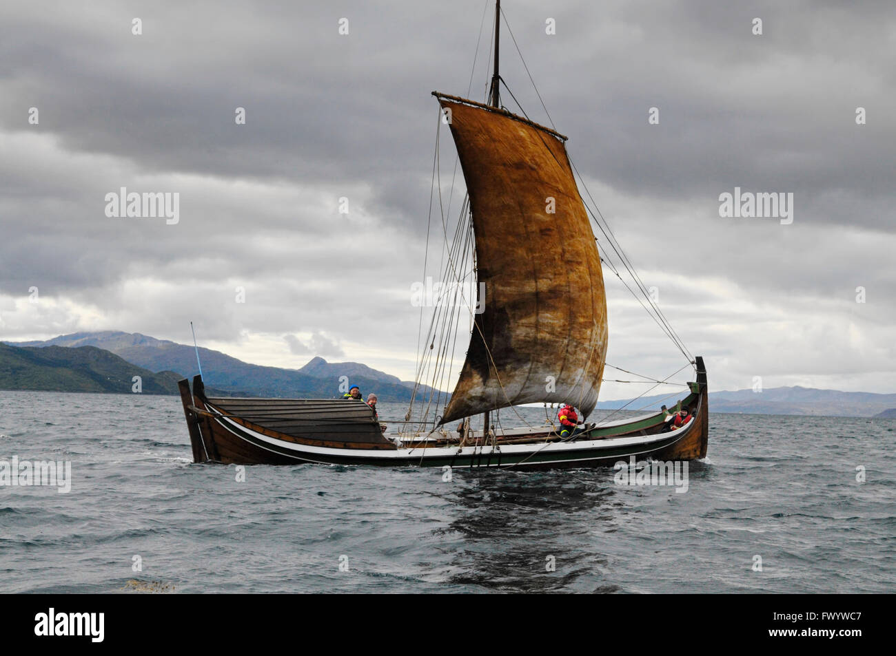 A traditional wooden nordland boat is sailing on ofotfjorden in northern norway stock photo