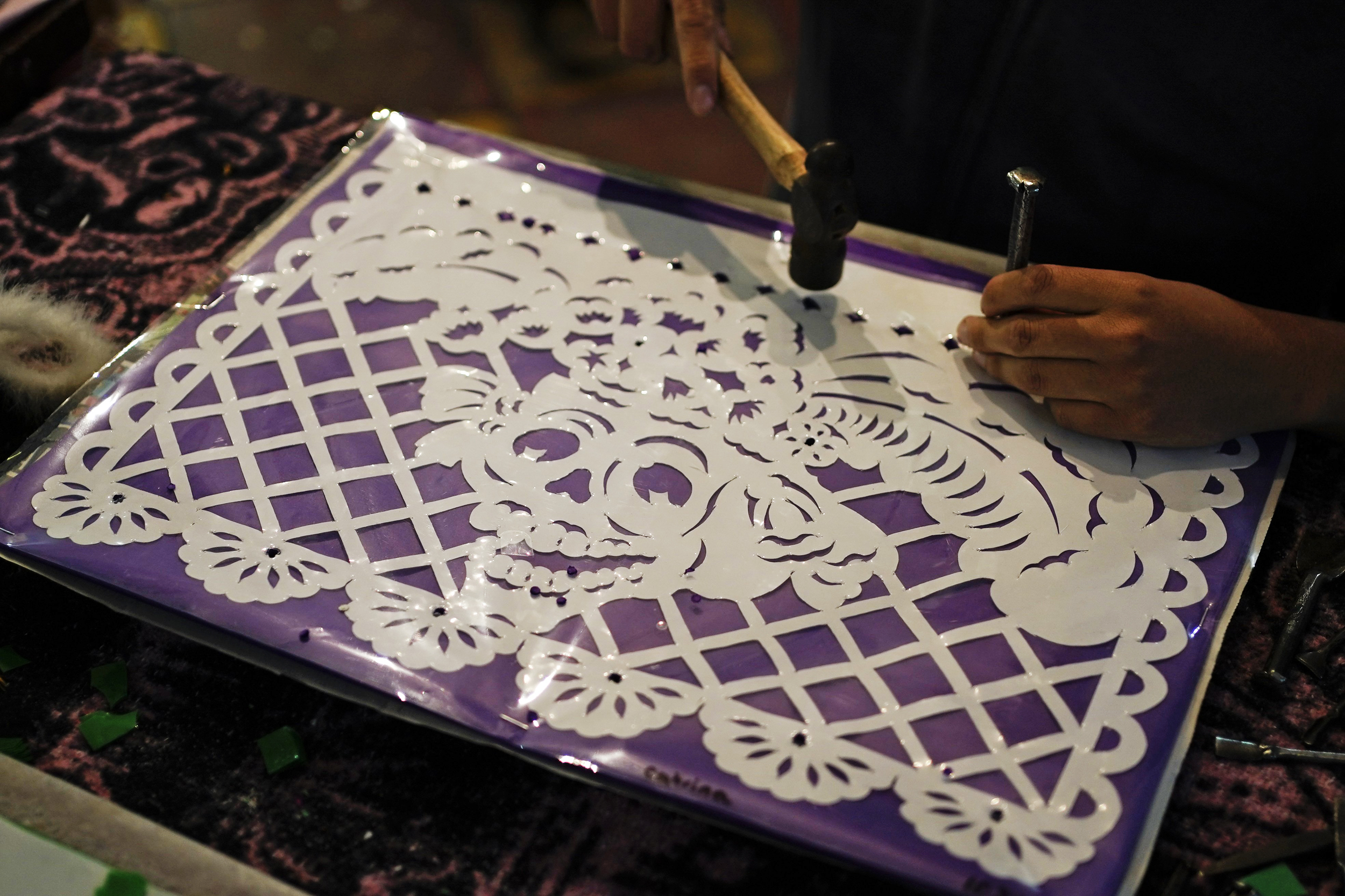 Mexico artisans make traditional papel picado for dia de muertos