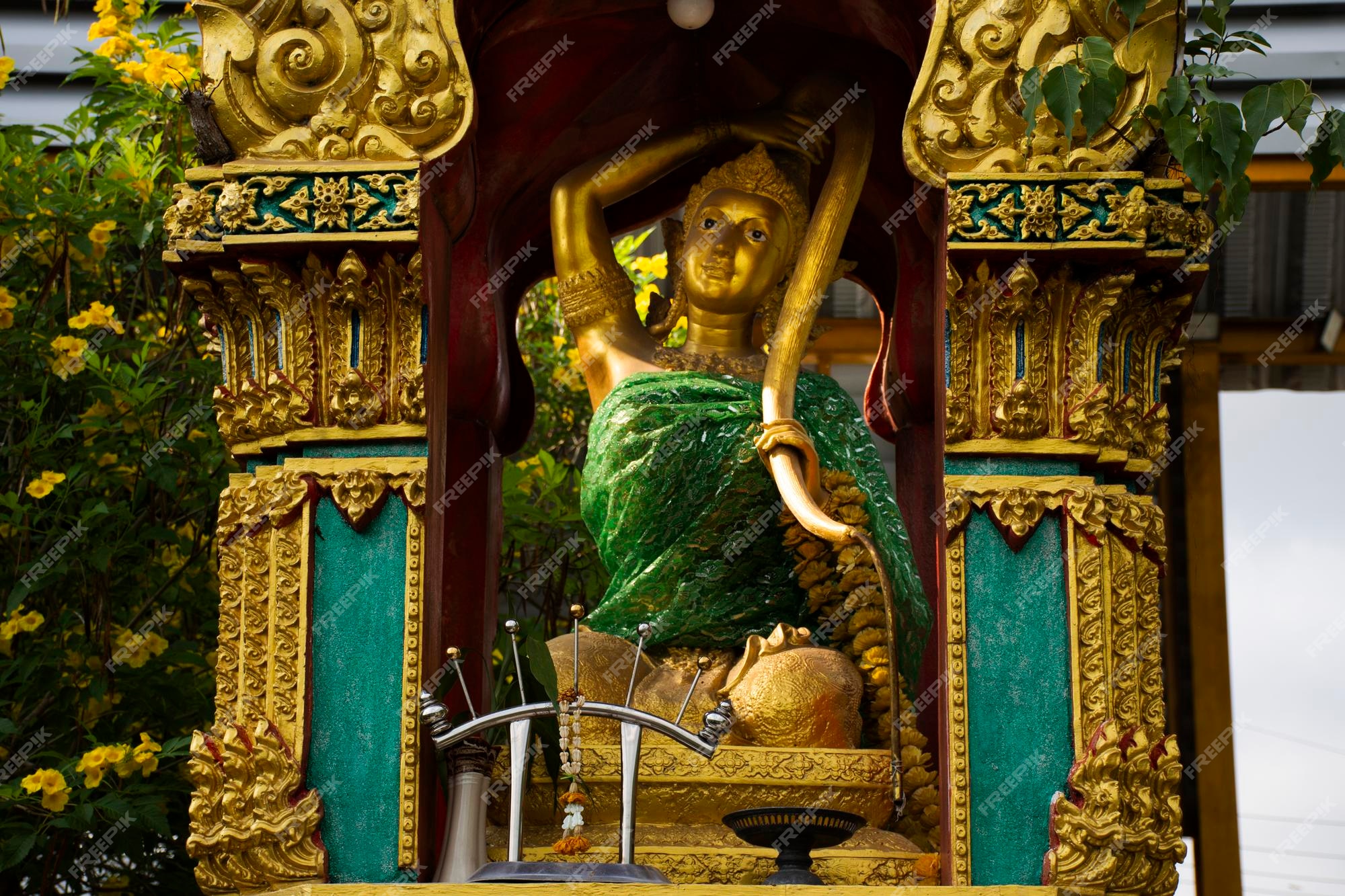 Premium photo phra mae thorani deity or vasundhara or dharani angel goddess ancient thai folklore in antique small shrine for thai people travel visit respect blessing at wat tanot temple in nonthaburi thailand