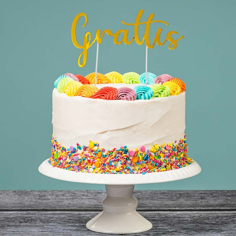 Kãp cake topper i guld med texten grattis hos