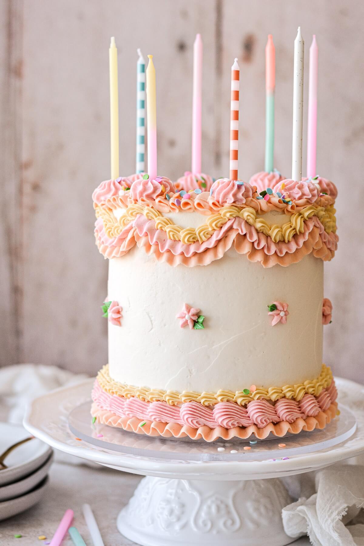 High altitude pastel party birthday cake with lambeth piping