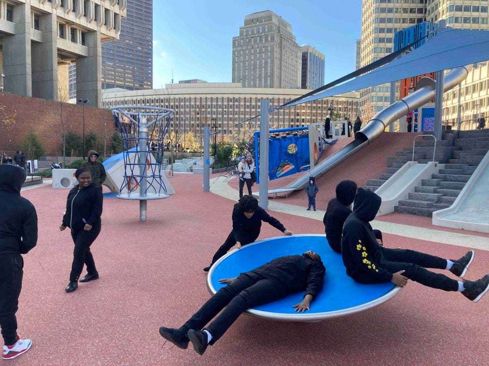 Video shows a boston police officer being launched from long slide at city hall plaza he was hurt but is fine