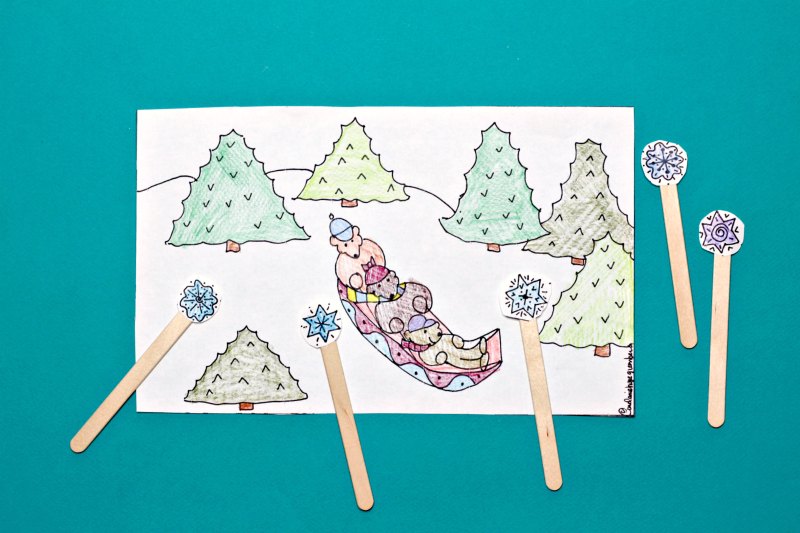 Sledding coloring page with snowflake puppets