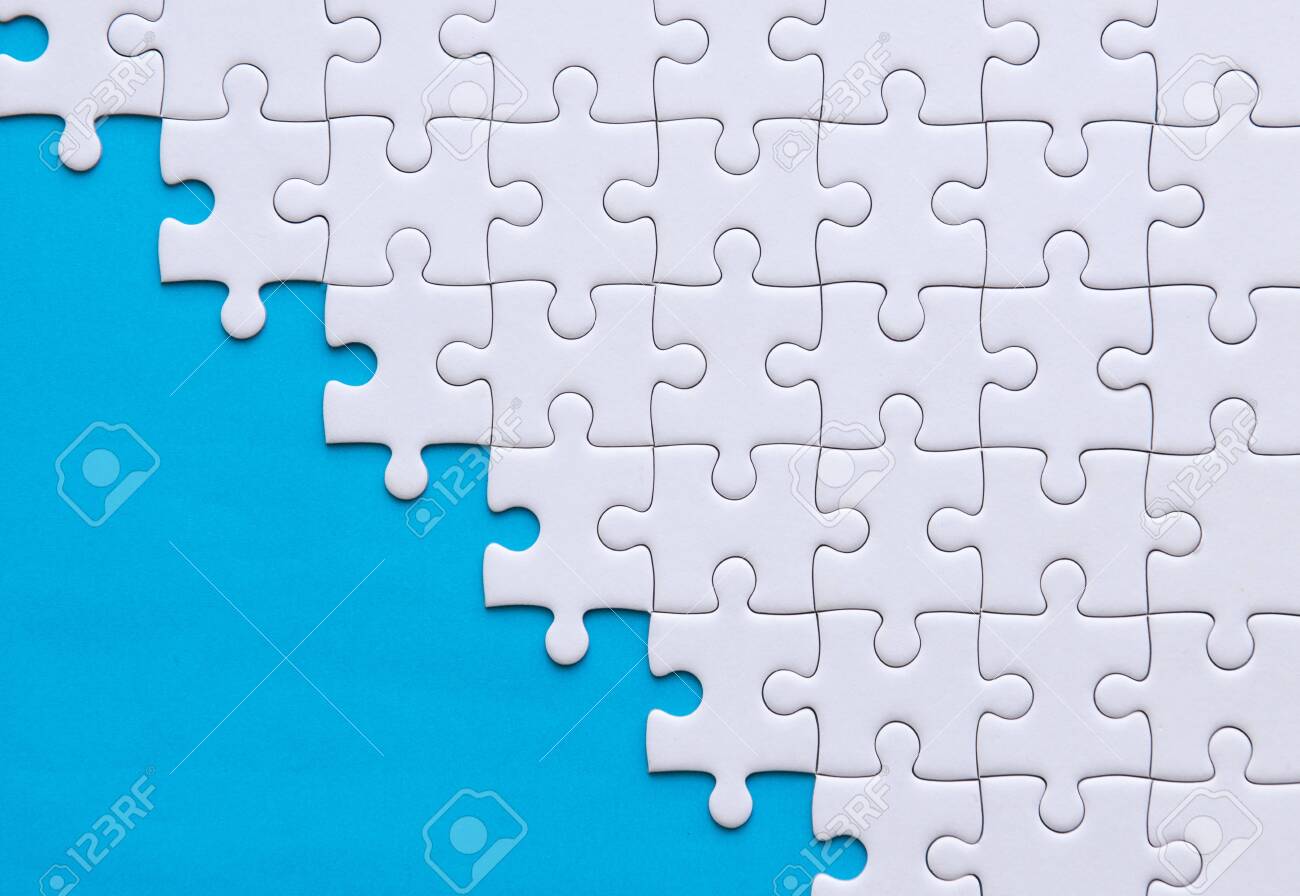 Jigsaw puzzle white colorpuzzles pieces gridsuccess mosaic solution templatehorizontal on blue color background copy space for texttop view stock photo picture and royalty free image image