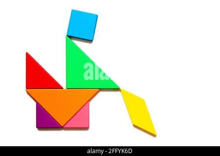 Color tangram puzzle in man sitting on chair or toilet in restroom shape on white background stock photo