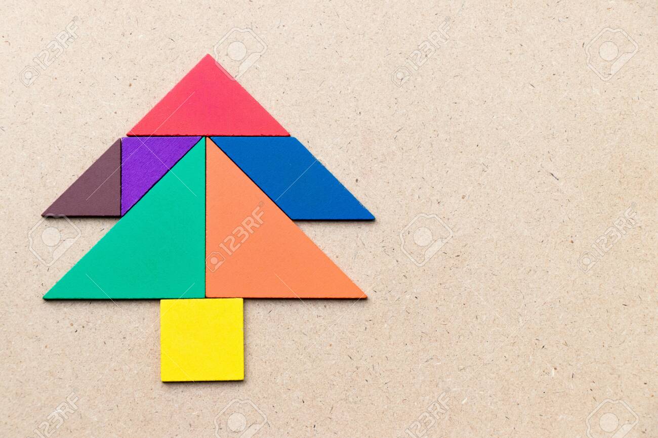 Color tangram in pine or christmas tree shape on wood background stock photo picture and royalty free image image