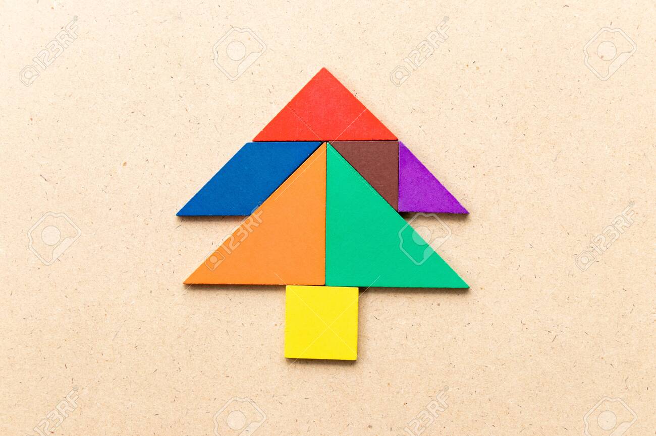 Color tangram puzzle in pine or christmas tree shape on wood background stock photo picture and royalty free image image