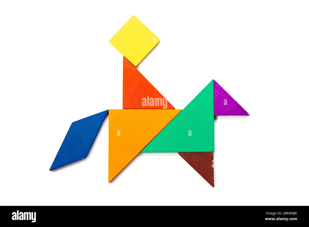 Color wood tangram puzzle in man ride on the horse shape on white background stock photo