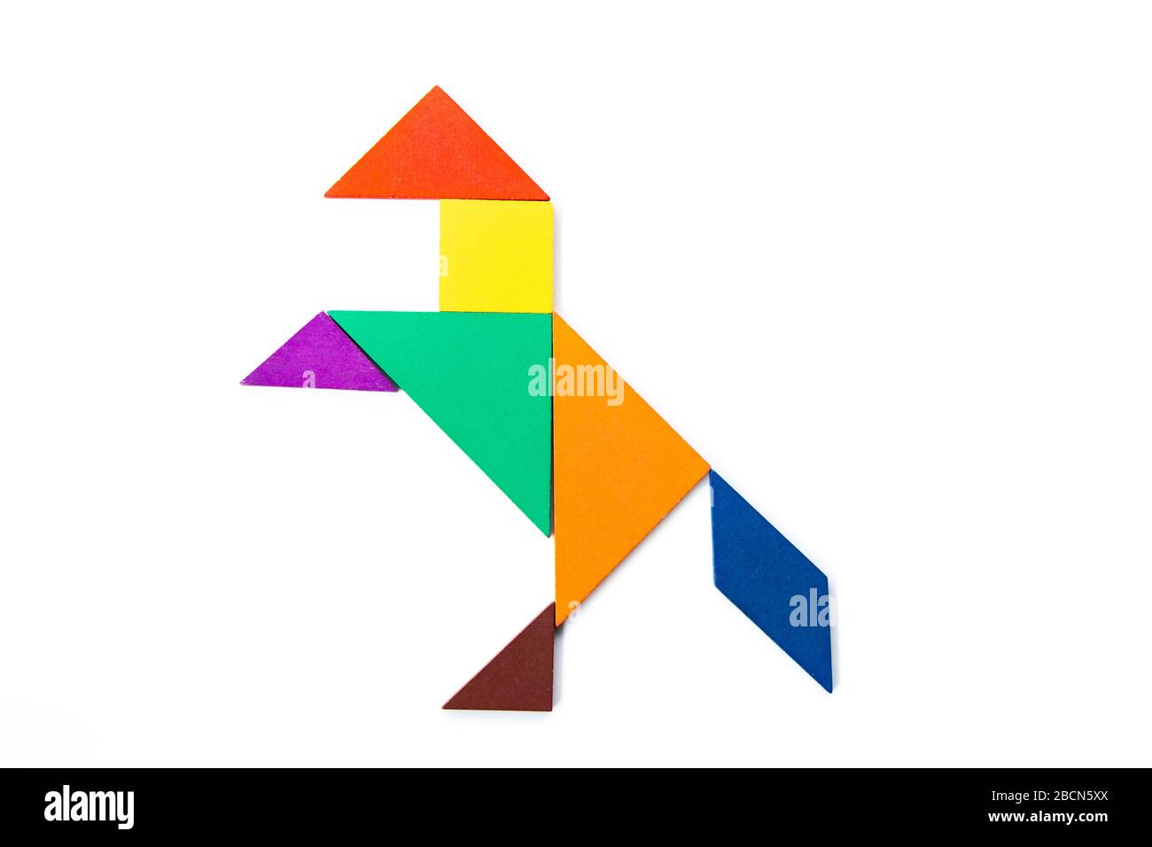 Color wood tangram puzzle in horse or mustang shape on white background stock photo