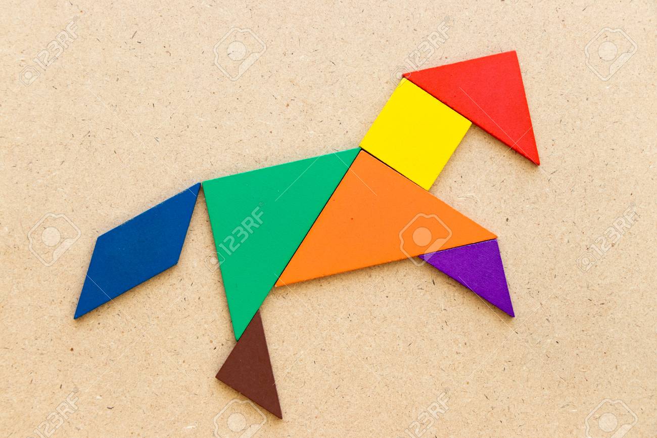 Color tangram puzzle in horse or mustang shape on wood background stock photo picture and royalty free image image