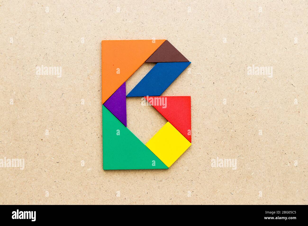 Tangram puzzle in alphabet letter b shape on wood background stock photo