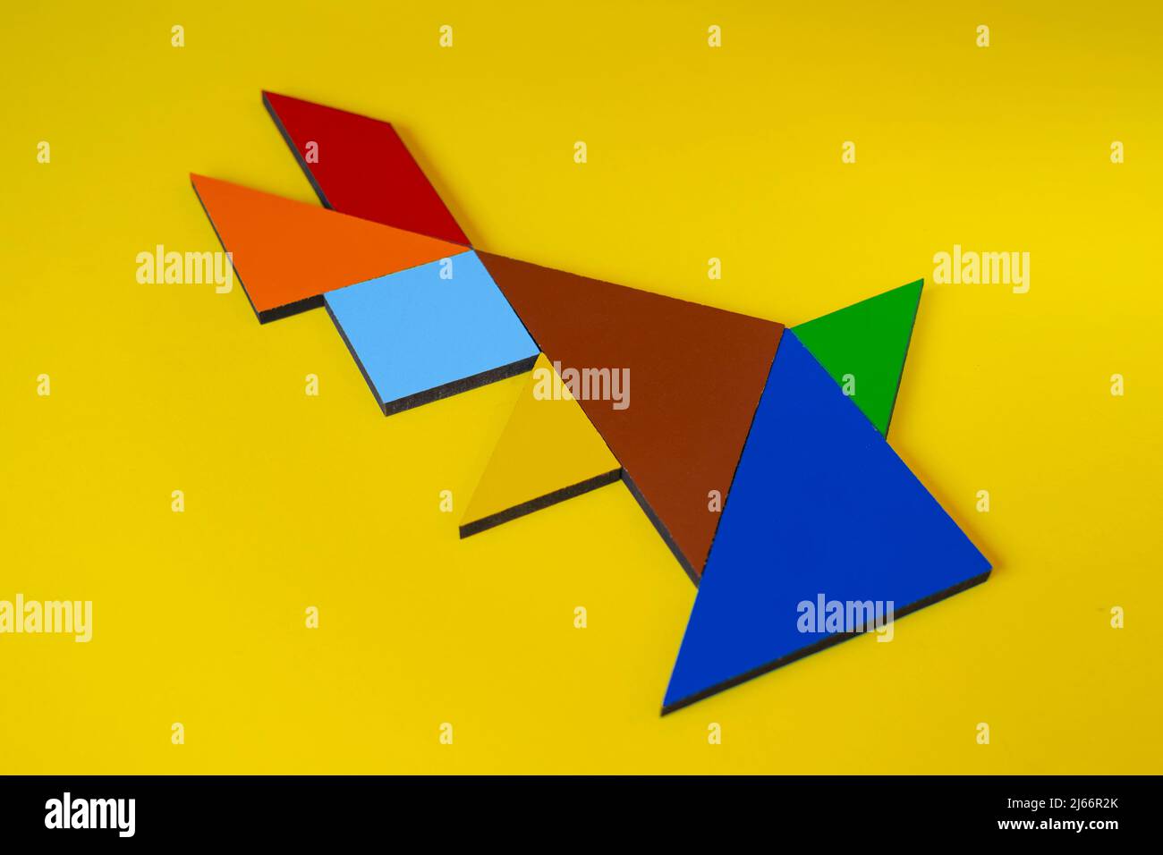 Tangram rabbit isolated on yellow background sitting view of tangram animal rabbit lay down colorful tangram puzzle toy concept stock photo