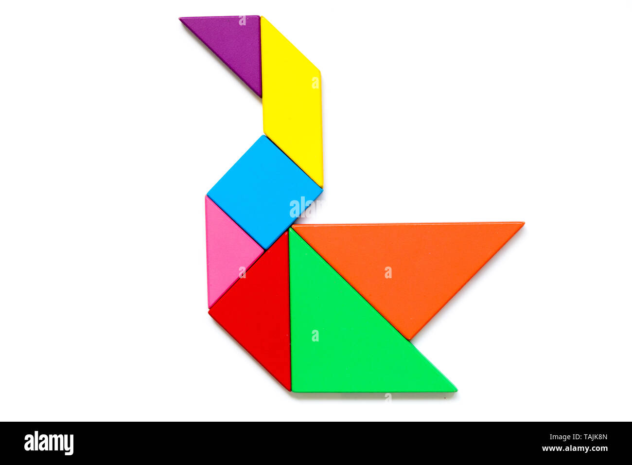 Color wood tangram puzzle in swan shape on white background stock photo