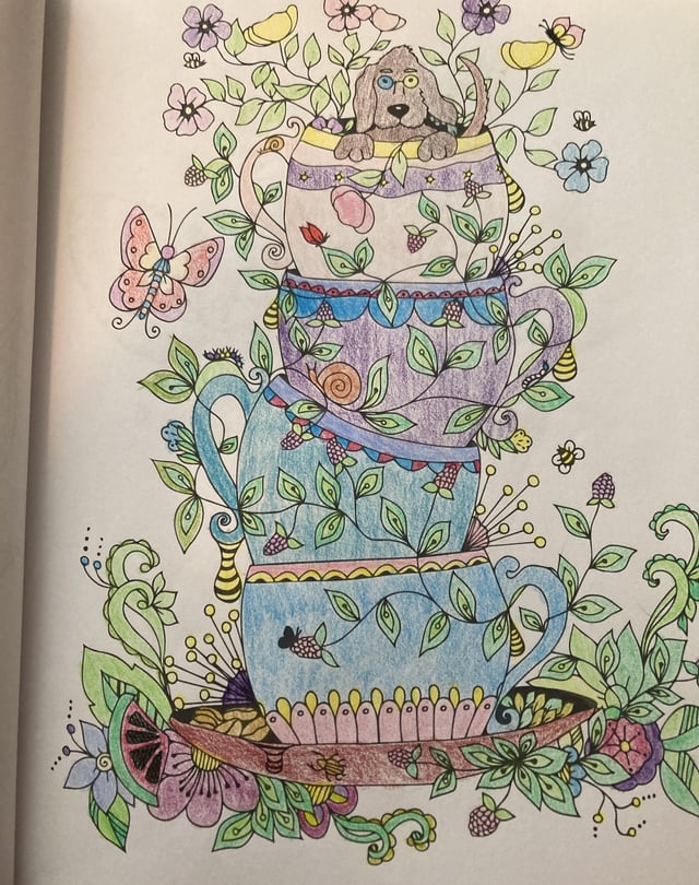A dog sitting in a stack of tea cups rcoloring