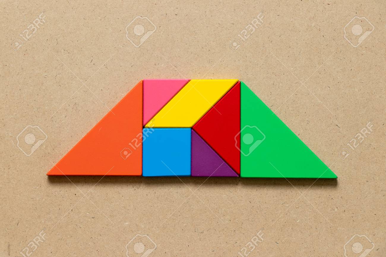 Color tangram puzzle in trapezoid shape on wood background stock photo picture and royalty free image image