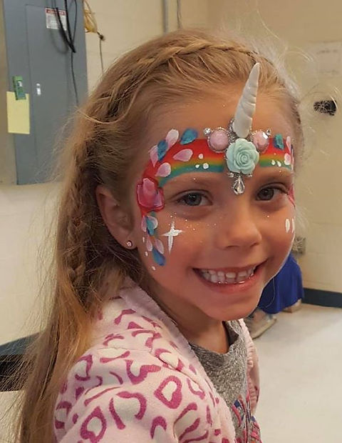 Unicorn party with horns with face paint glitter glossand hair coloring
