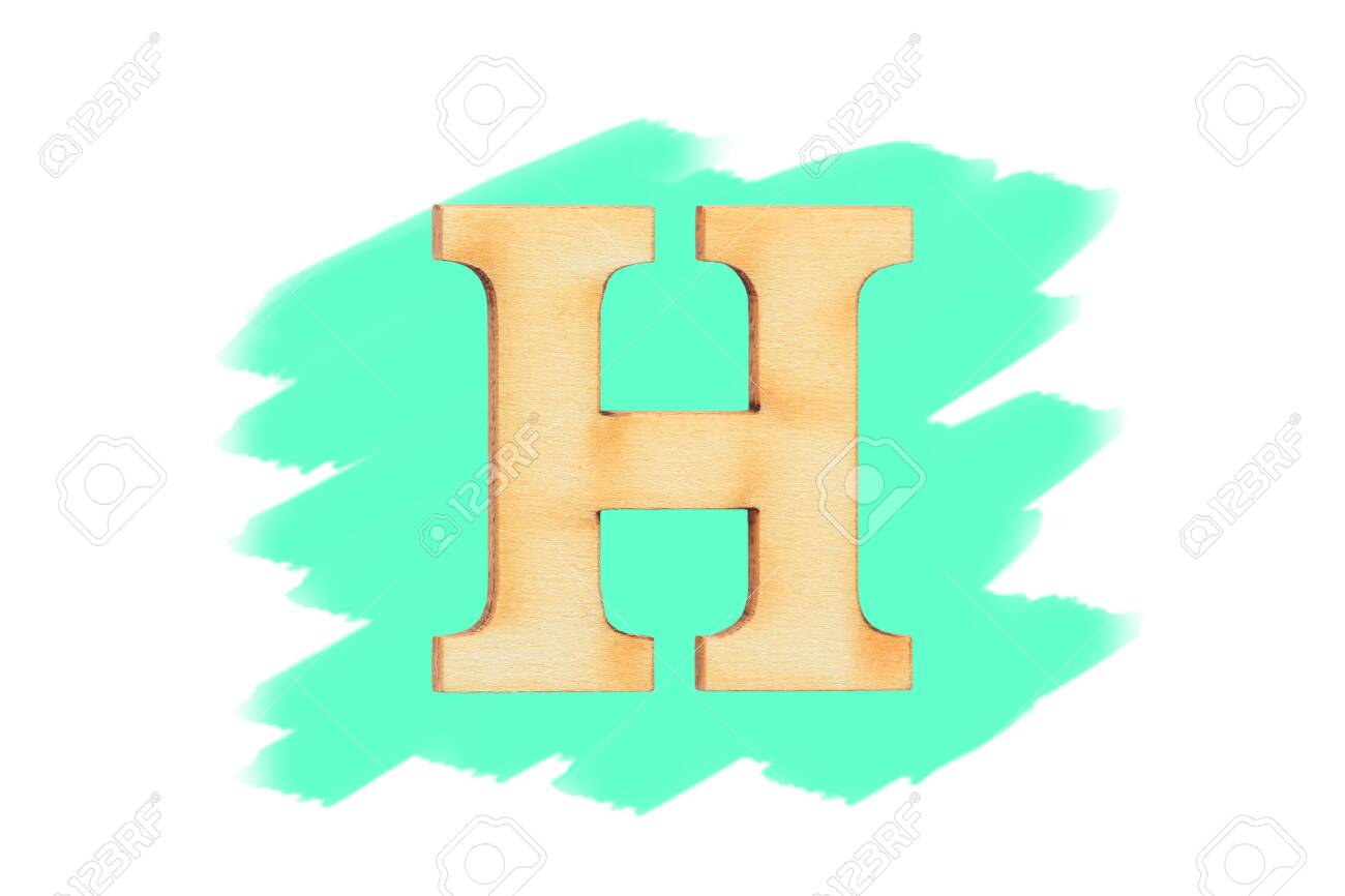 Alphabet letter wooden font on painted color green isolated on white background english flat wood character h stock photo picture and royalty free image image